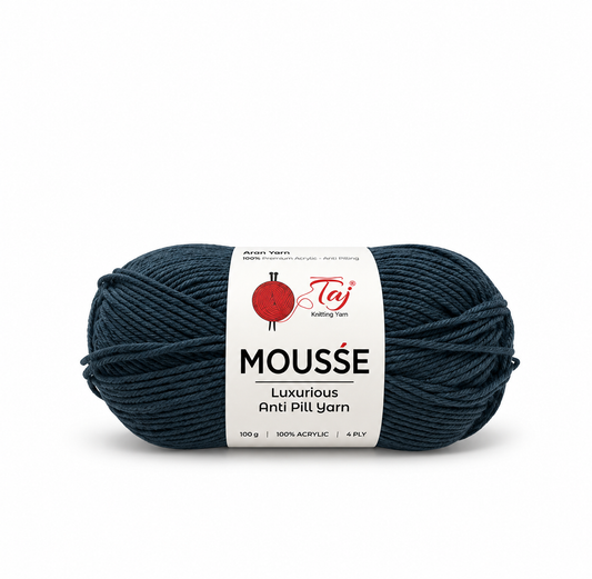 A single skein of Taj Mousse luxurious anti-pill yarn in a dark navy blue color, wrapped with a white paper label showing the brand logo and product details, on a clean white background.