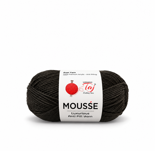 A single skein of black yarn with a white paper label reading 'MOUSSE' and showing the Taj Knitting Yarn logo, photographed on a clean white background.