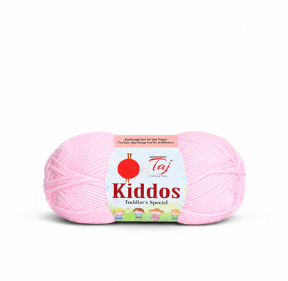A skein of light pink yarn with a paper label reading 'Kiddos Toddler's Special' and 'Vagabond Taj', photographed on a clean white background.