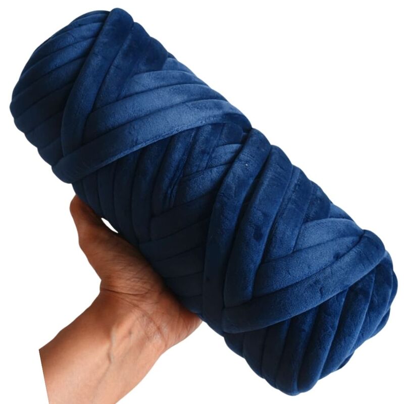 Hand holding a large ball of blue yarn against a white background