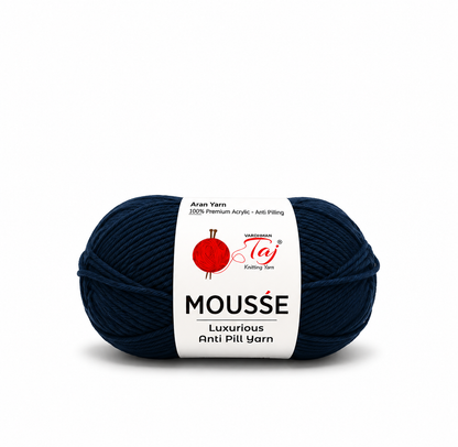 A single skein of dark navy blue yarn with a white paper label. The label features the brand name 'Madison Taj' and the product line 'MOUSSE'.