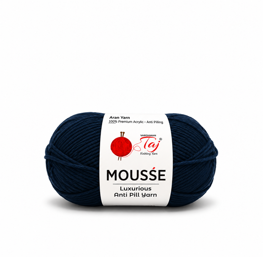 A single skein of dark navy blue yarn with a white paper label. The label features the brand name 'Madison Taj' and the product line 'MOUSSE'.