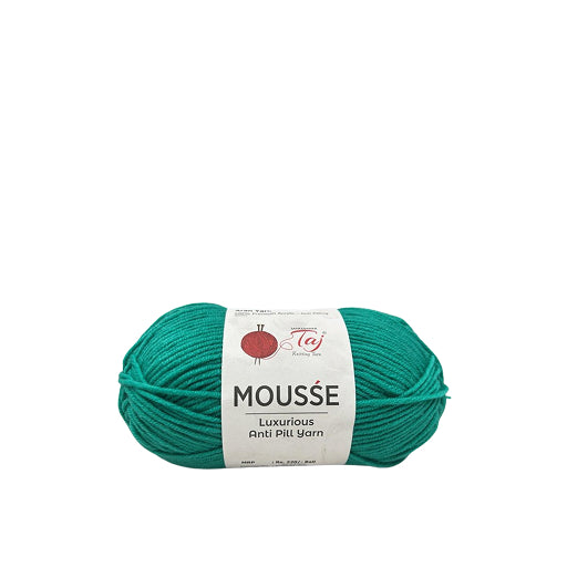 Teal skein of Mousse yarn with a label on a white background