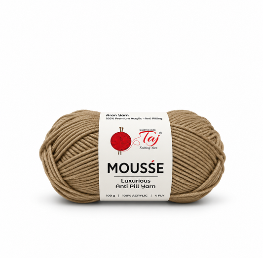 A single skein of Teji Mousse luxurious anti-pill yarn in a warm taupe-brown color, featuring a white paper label with red and black branding, set against a plain white background.