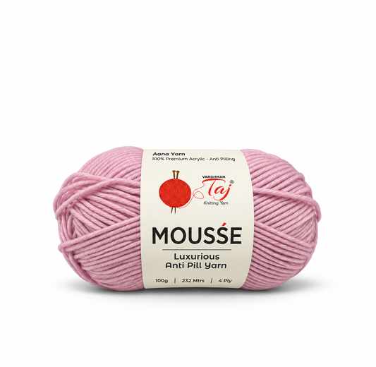 A single skein of Mousse Luxurious Anti Pili Yarn in dusty pink, featuring a white paper label with the Taj Knitting Yarn logo, on a clean white background.