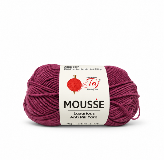 A skein of Taj Mousse Luxurious Anti Piling yarn in a deep berry purple shade, featuring a white paper label with the brand logo.