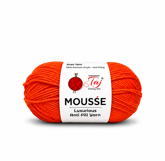 A bright orange-red ball of Mousse Anti Pill Yarn by Varzaman Taj, wrapped in a white paper label, on a clean white background.
