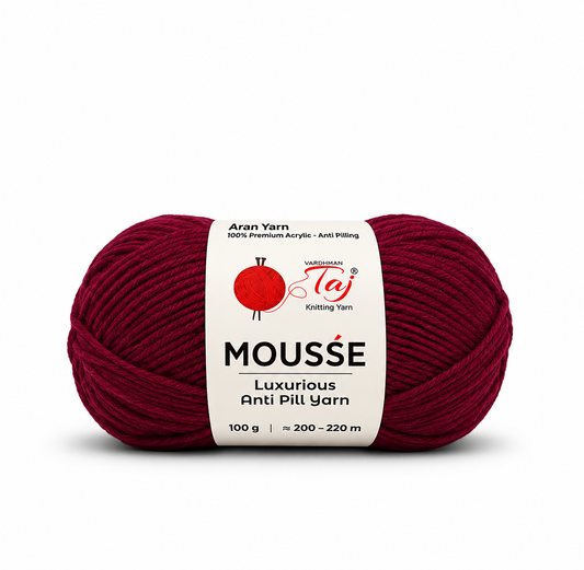 A single skein of Moussé Anti Pill Yarn in a deep burgundy red color, featuring a white paper label with the brand logo 'Taj Knitting Yarn'.