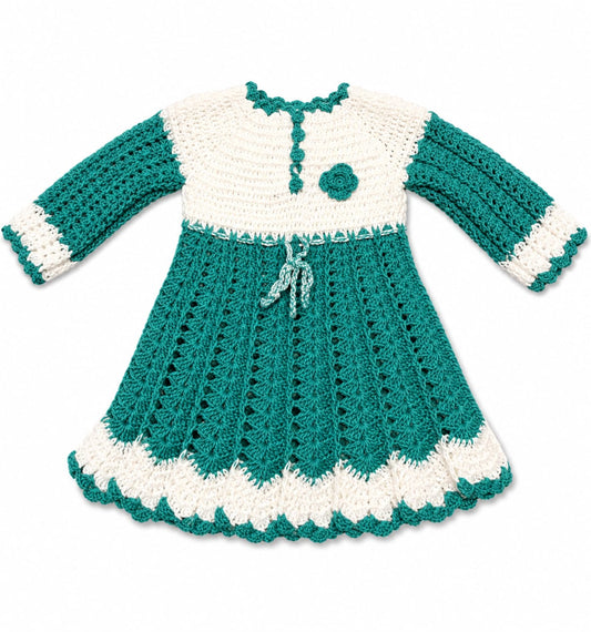 A handmade crocheted baby dress in teal green and white, featuring long sleeves