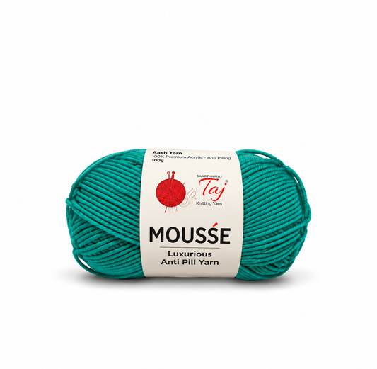 A skein of teal anti-pill mousse yarn with a white paper label, photographed on a clean white background.