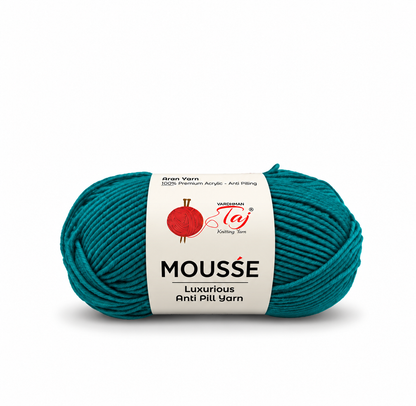 A skein of Wackenroder MOUSSE Luxurious Anti Pilling yarn in a deep teal color, wrapped with a white paper label showing the brand logo.
